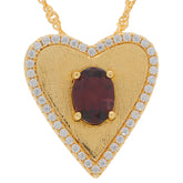 Gold heart pendant with red garnet center and diamond accents, perfect for elegant jewelry collection.
